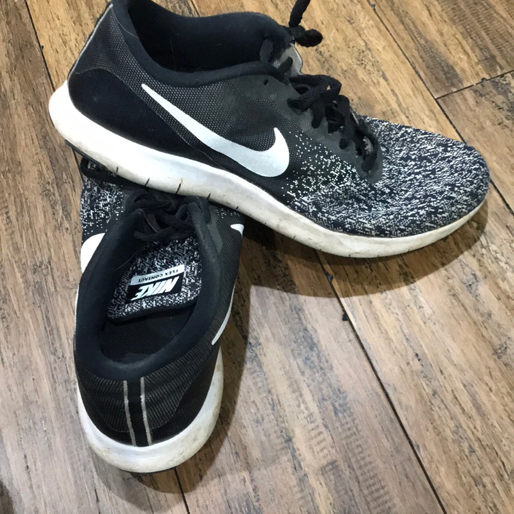 Very worn Nike tennis shoes